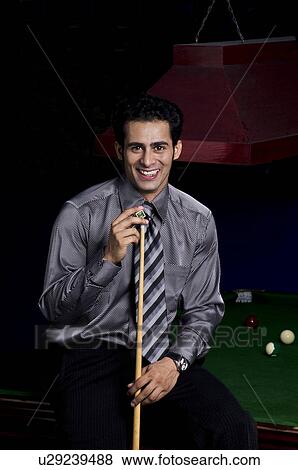 Man holding cue stick View Large Photo Image Stock Photo - Man holding cue stick. Fotosearch