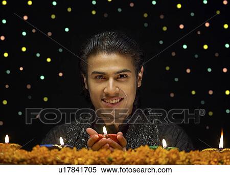 Stock Photography - Man holding Diya. Fotosearch