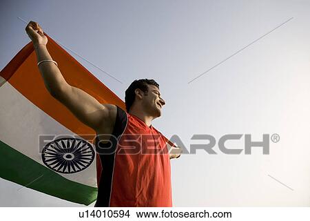 Man holding the national flag View Large Photo Image Picture - Man holding the national flag. Fotosearch