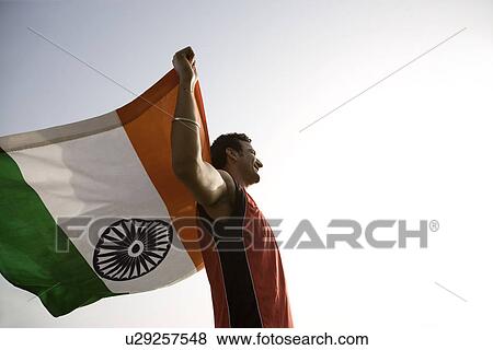 Stock Photo - Man holding the national flag. Fotosearch