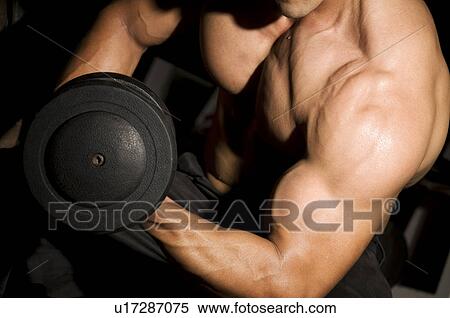 Stock Photography - Man lifting weights. Fotosearch