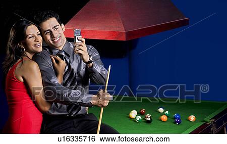 Man looking at his phone View Large Photo Image Stock Photograph - Man looking at his phone. Fotosearch