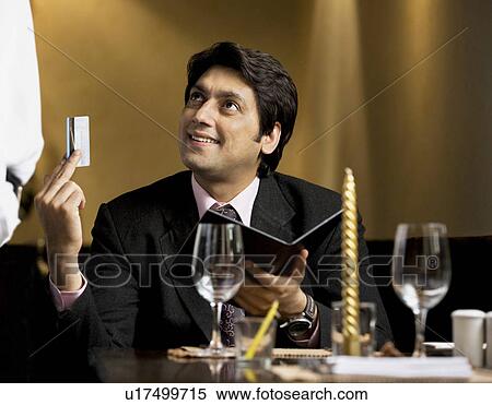 Stock Photography - Man paying the bill. Fotosearch