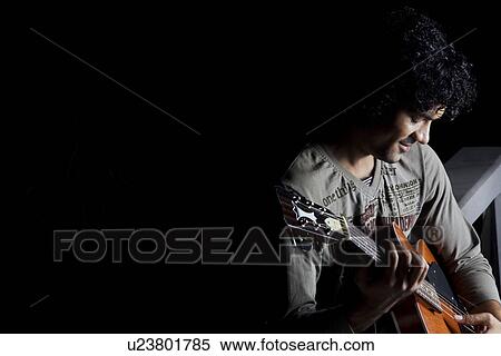 Stock Photography - Man playing the guitar. Fotosearch
