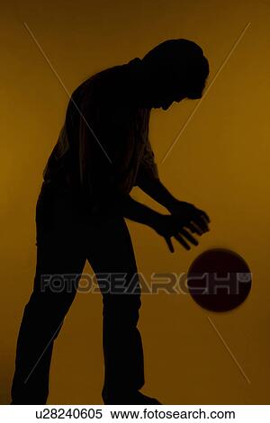 Stock Photography - Man playing with a ball. Fotosearch