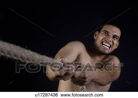 Stock Photograph - Man pulling a rope. Fotosearch