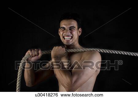 Stock Photograph - Man pulling a rope. Fotosearch