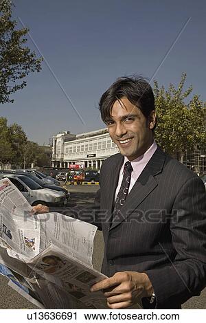 Stock Image - Man reading newspaper. Fotosearch