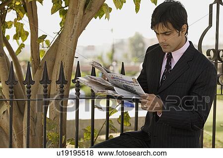 Stock Photo - Man reading newspaper. Fotosearch