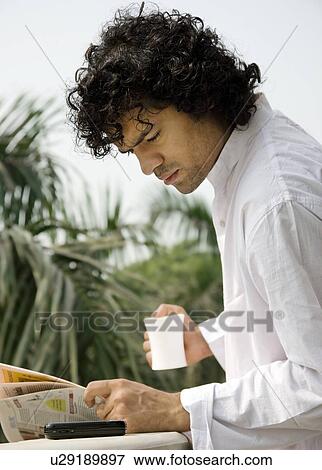 Stock Photo - Man reading the newspaper. Fotosearch