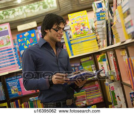 Man selecting a book View Large Photo Image Stock Image - Man selecting a book. Fotosearch