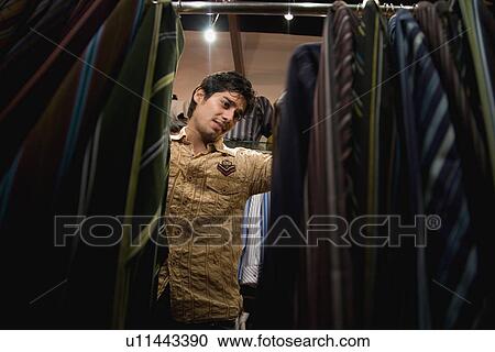 Man selecting a suit View Large Photo Image Stock Image - Man selecting a suit. Fotosearch
