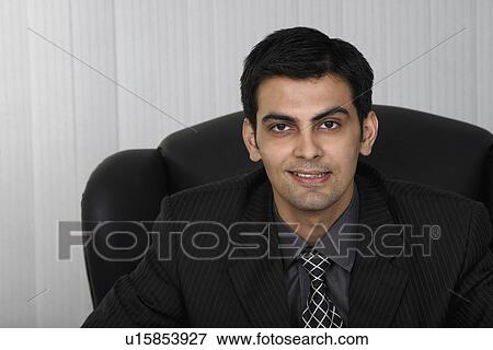 Man sitting in the office View Large Photo Image Stock Photo - Man sitting in the office. Fotosearch