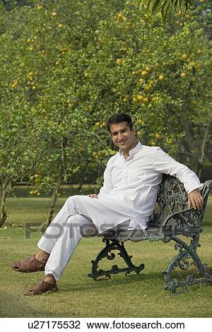 Stock Image - Man sitting on a bench. Fotosearch