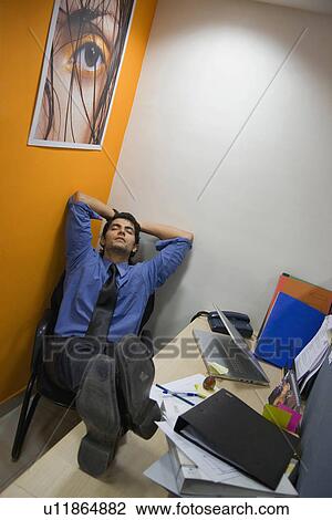 Stock Image - Man sleeping in the office. Fotosearch