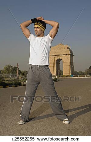 Stock Photography - Man standing in front of the India Gate. Fotosearch