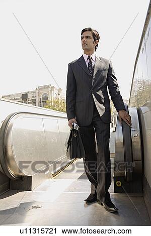 Stock Image - Man standing near the elevators. Fotosearch