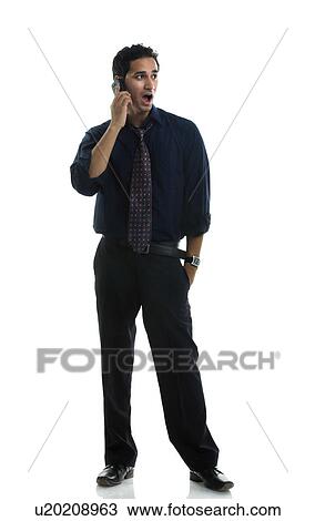 Stock Image - Man talking on his cell phone. Fotosearch