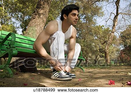 Stock Photo - Man tying shoelace. Fotosearch