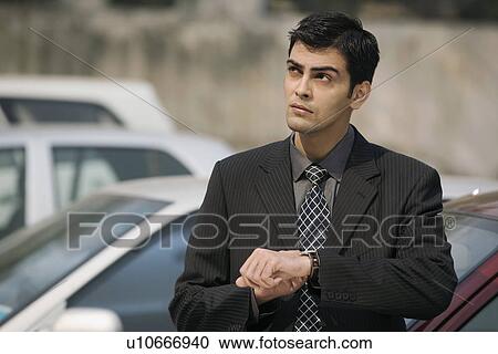 Stock Image - Man waiting outside the office. Fotosearch