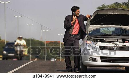 Man with a broken car View Large Photo Image Stock Image - Man with a broken car. Fotosearch