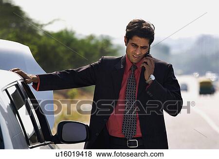 Stock Photo - Man with a broken car. Fotosearch