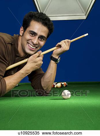 Man with cue stick View Large Photo Image Stock Photography - Man with cue stick. Fotosearch