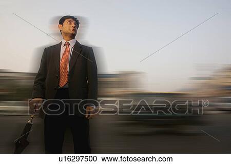 Stock Image - Man with umbrella. Fotosearch