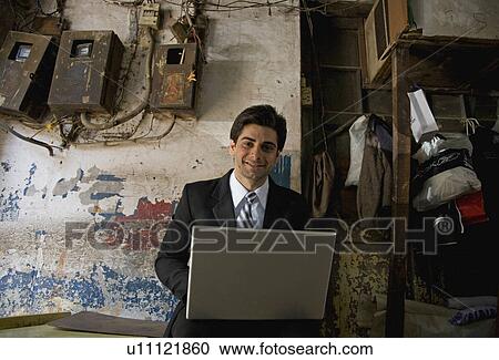 Man working on a laptop View Large Photo Image Stock Image - Man working on a laptop. Fotosearch