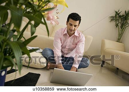 Man working on a laptop View Large Photo Image Stock Photo - Man working on a laptop. Fotosearch