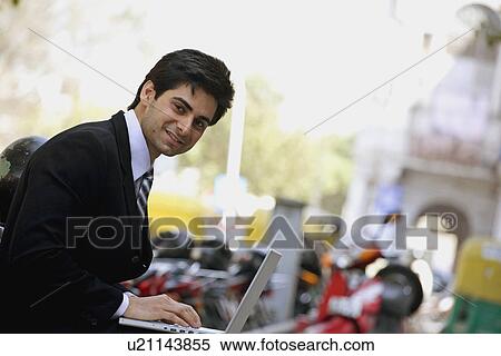 Man working on a laptop View Large Photo Image Stock Photography - Man working on a laptop. Fotosearch