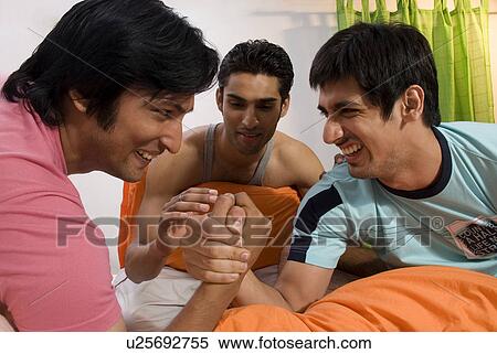 Stock Photography - Men doing hand wrestling. Fotosearch