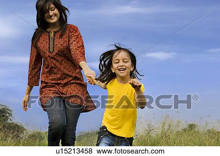 Stock Photo - Mother and daughter in a park. Fotosearch