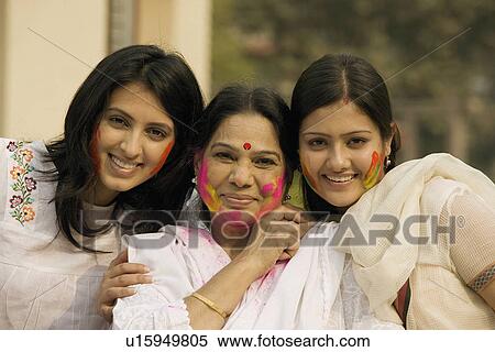 Stock Photography - Mother with her daughters during Holi. Fotosearch