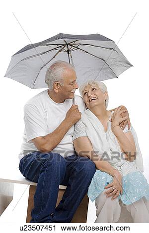 Old couple under an umbrella View Large Photo Image Stock Image - Old couple under an umbrella. Fotosearch