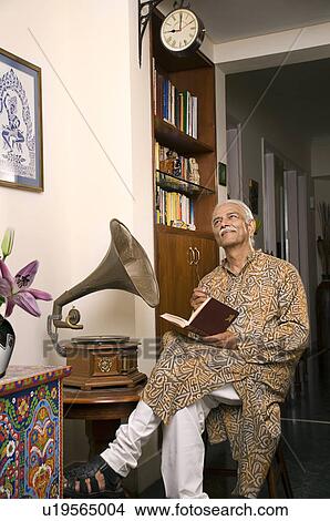 Old man relaxing in his house View Large Photo Image Picture - Old man relaxing in his house. Fotosearch