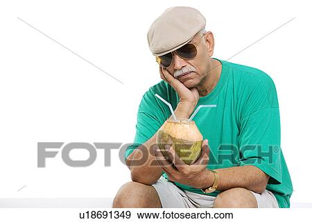 Stock Photo - Old man with a coconut drink. Fotosearch
