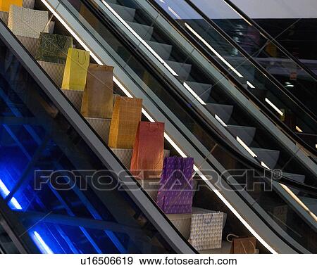 Stock Photo - Paper bags on escalator. Fotosearch
