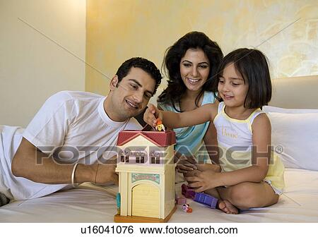 Parents playing with their daughter View Large Photo Image Stock Photograph - Parents playing with their daughter. Fotosearch