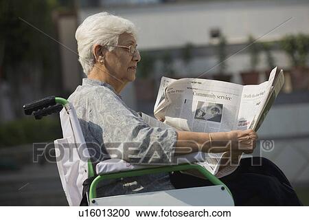 Stock Image - Patient reading the newspaper. Fotosearch
