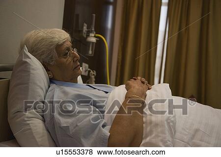 Stock Photo - Patient resting in hospital bed. Fotosearch
