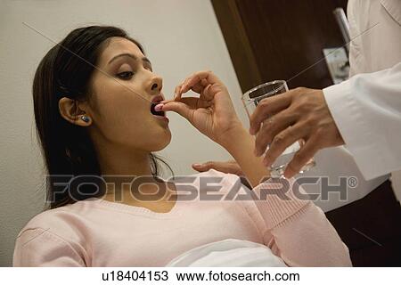 Patient takes her medication View Large Photo Image Stock Image - Patient takes her medication. Fotosearch