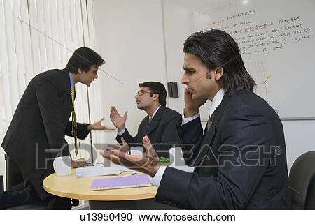 Stock Image - People during a meeting. Fotosearch