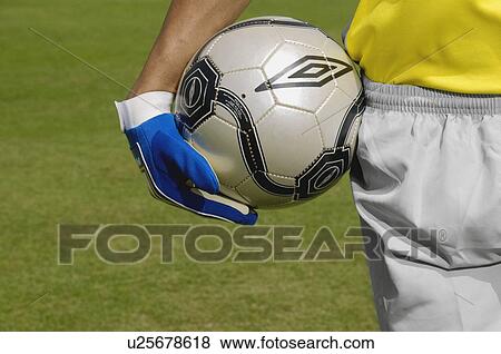 Player holding a football View Large Photo Image Stock Photo - Player holding a football. Fotosearch