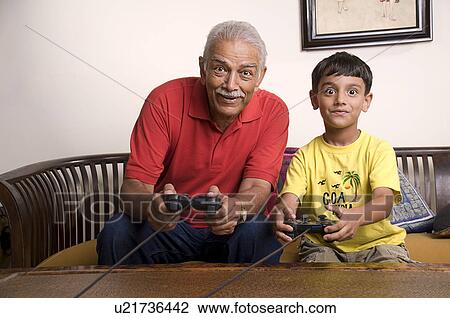 Stock Image - Playing video games. Fotosearch