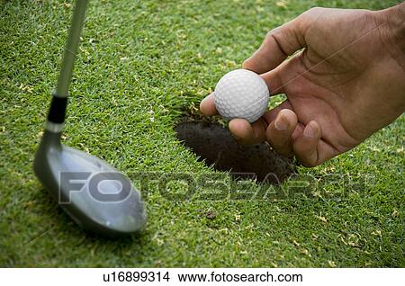 Positioning golf ball on tee View Large Photo Image Picture - Positioning golf ball on tee. Fotosearch