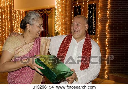 Presenting a Diwali gift View Large Photo Image Picture - Presenting a Diwali gift. Fotosearch