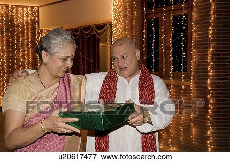 Presenting a Diwali gift View Large Photo Image Stock Photo - Presenting a Diwali gift. Fotosearch