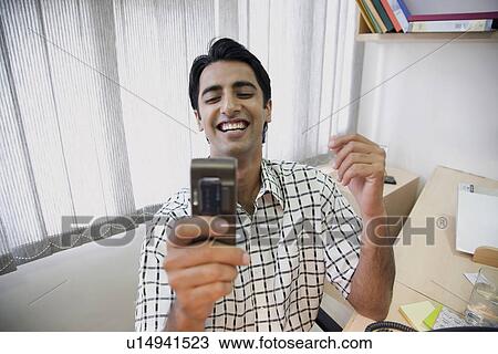 Reading an SMS View Large Photo Image Stock Image - Reading an SMS. Fotosearch