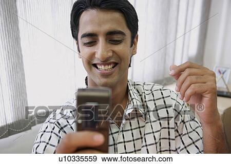 Reading an SMS View Large Photo Image Stock Photo - Reading an SMS. Fotosearch